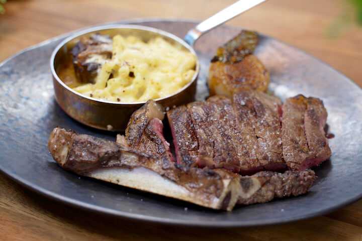 Dry age sirloin steak with an oxtail mac and cheese and Roscoff onions