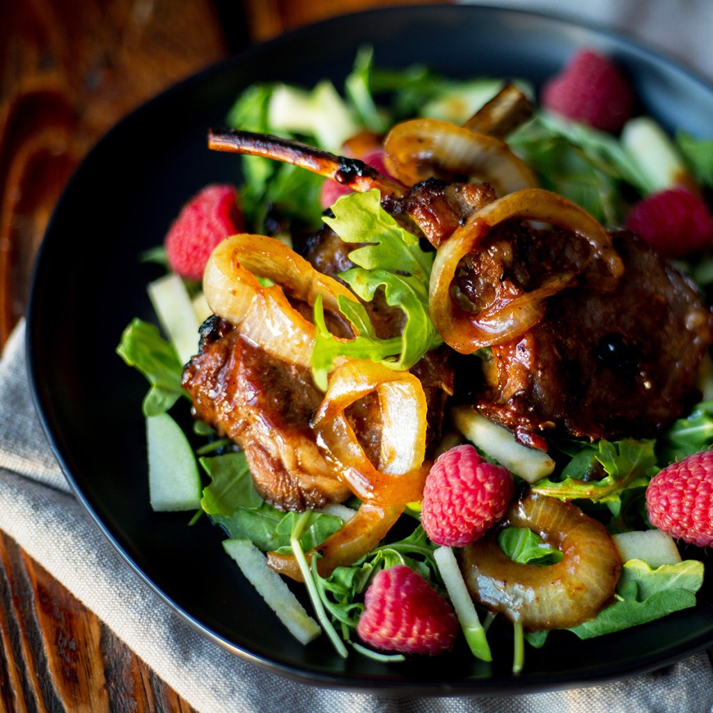 Meat dish served with colourful salad