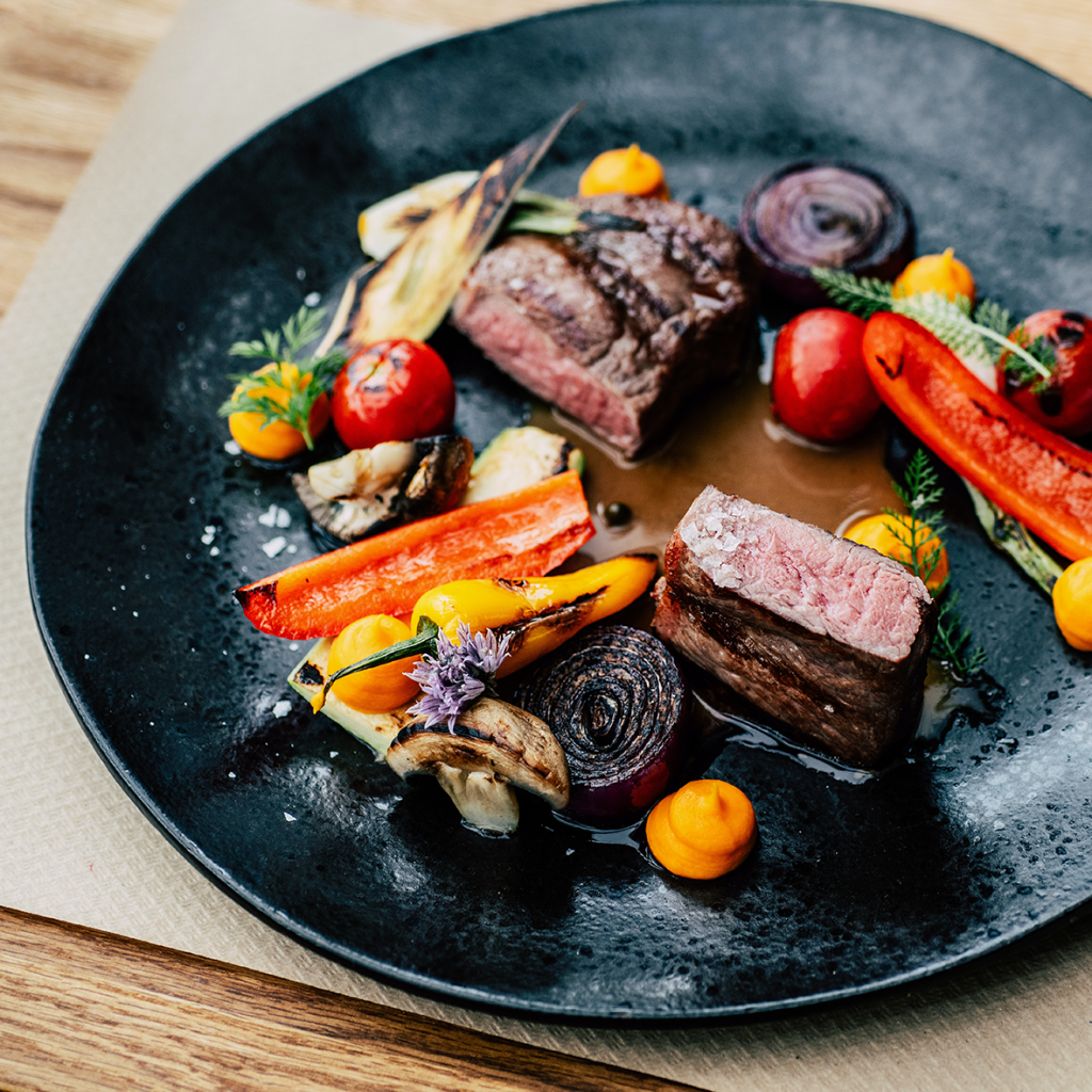 Steak served with colourful vegetables